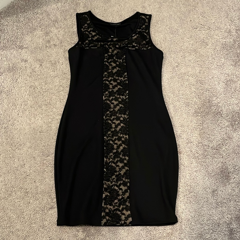 Black form fitting dress. Never worn. NWT.